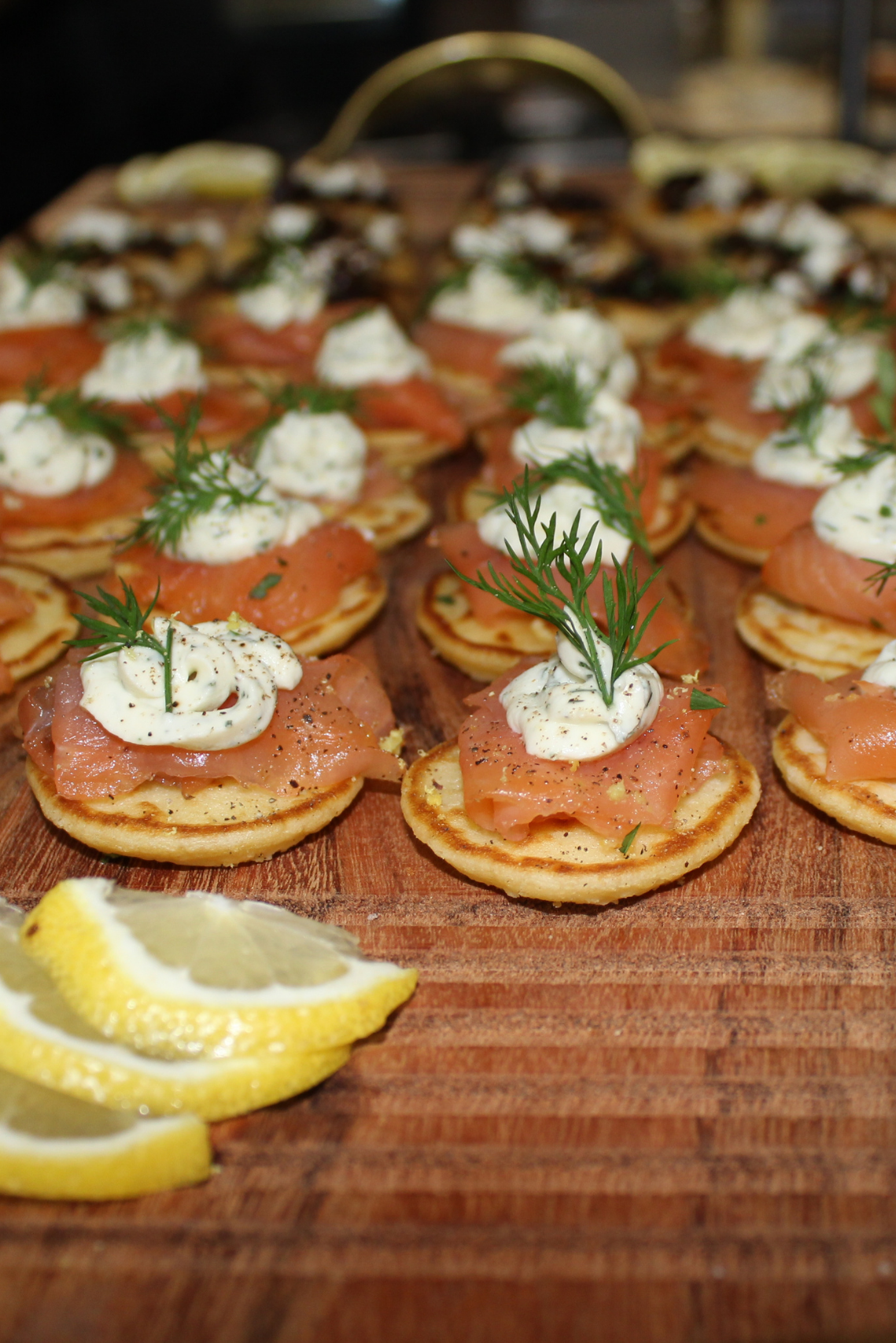 tray of blinis with lemon slices