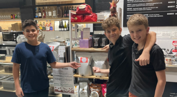 Photo of Arlee, Rocco and Cristiano standing next to their first bag of ARC Reserve coffee